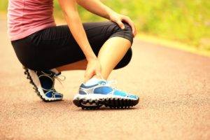 Athlete Rubbing Ankle