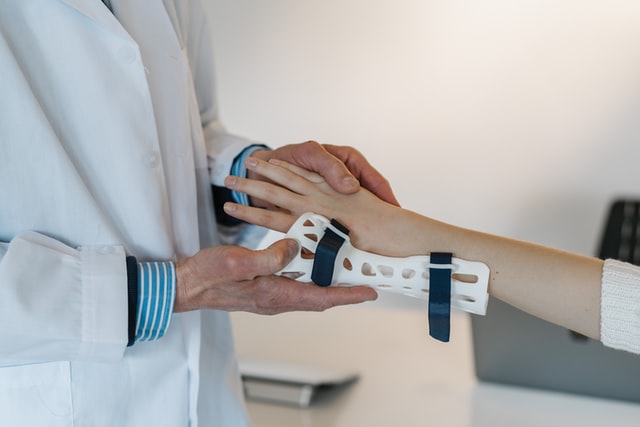 a pediatric orthopedist working with a child on an injury